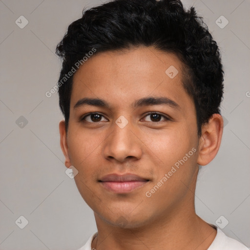 Joyful latino young-adult male with short  black hair and brown eyes