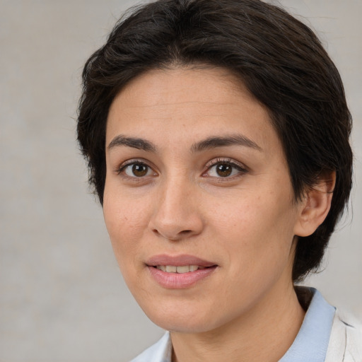 Joyful white adult female with medium  brown hair and brown eyes