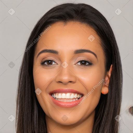 Joyful latino young-adult female with long  brown hair and brown eyes