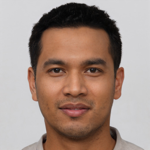 Joyful asian young-adult male with short  black hair and brown eyes