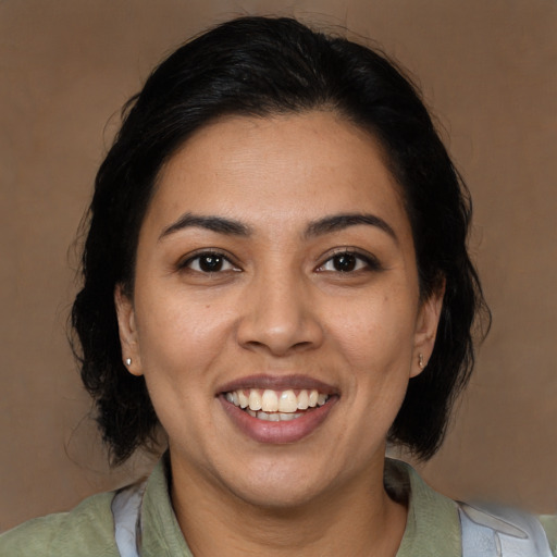 Joyful latino young-adult female with medium  black hair and brown eyes