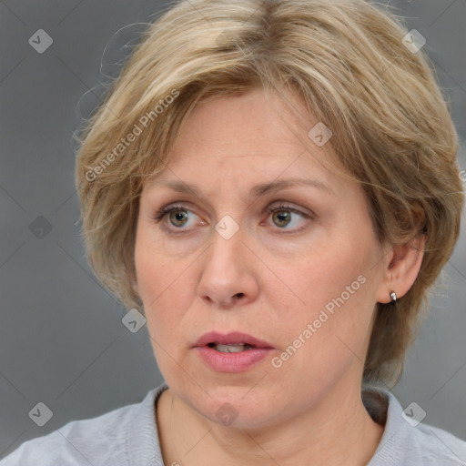 Joyful white adult female with medium  brown hair and blue eyes