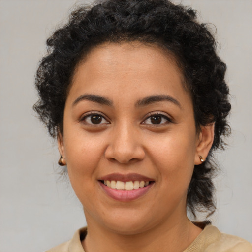 Joyful latino young-adult female with medium  brown hair and brown eyes