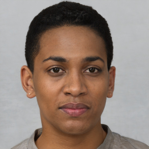Joyful black young-adult female with short  black hair and brown eyes