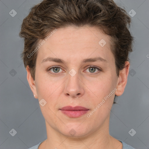 Joyful white adult female with short  brown hair and grey eyes