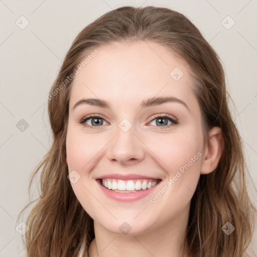 Joyful white young-adult female with long  brown hair and green eyes