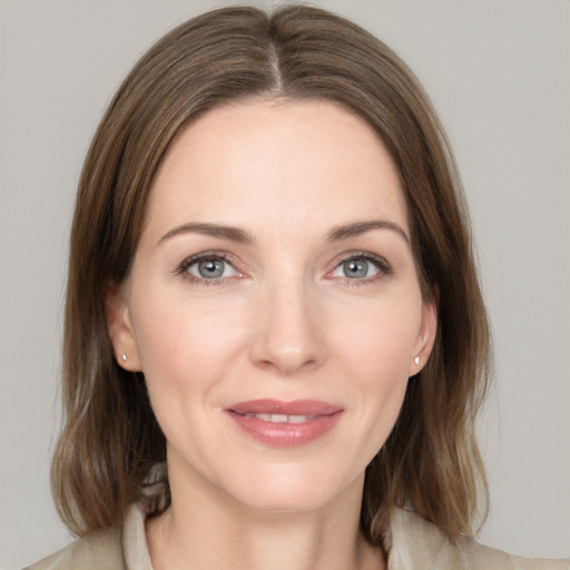 Joyful white young-adult female with medium  brown hair and grey eyes