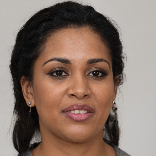 Joyful black young-adult female with medium  brown hair and brown eyes