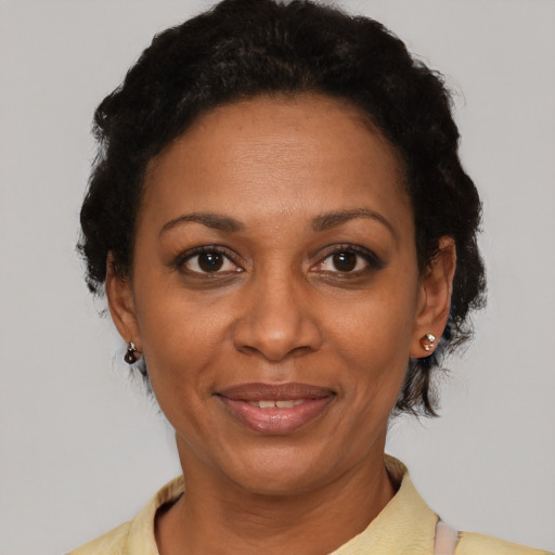 Joyful black adult female with short  brown hair and brown eyes