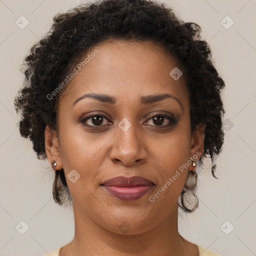 Joyful black adult female with short  brown hair and brown eyes