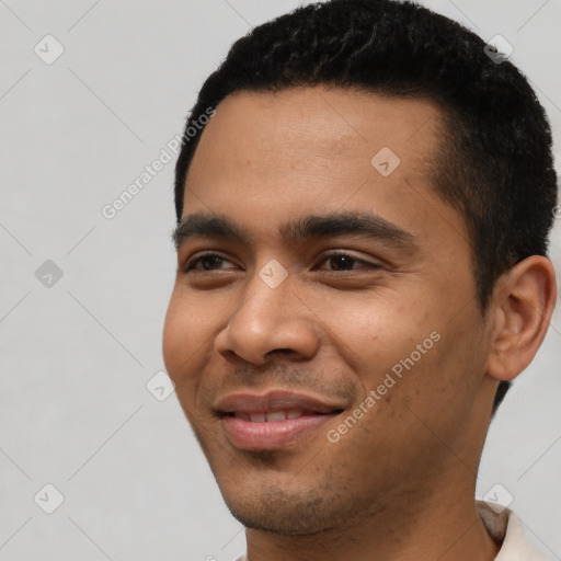 Joyful latino young-adult male with short  black hair and brown eyes