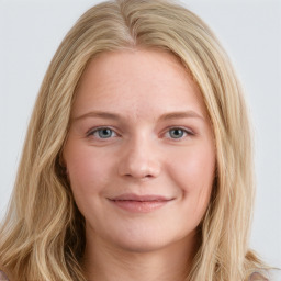 Joyful white young-adult female with long  brown hair and blue eyes