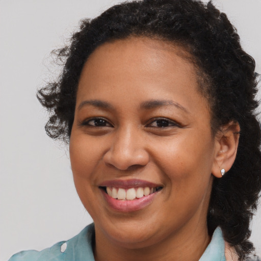 Joyful black young-adult female with medium  brown hair and brown eyes