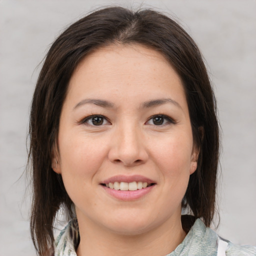 Joyful white young-adult female with medium  brown hair and brown eyes