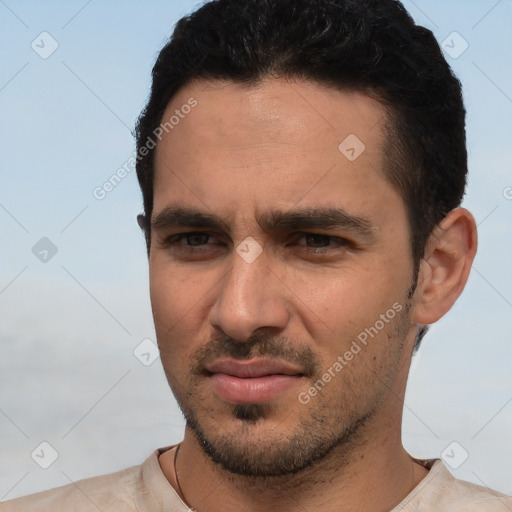 Joyful white young-adult male with short  black hair and brown eyes