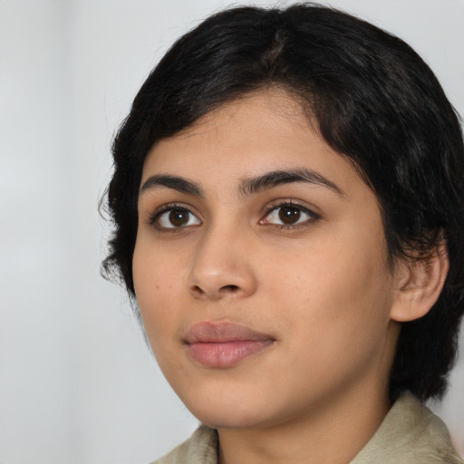 Joyful latino young-adult female with medium  black hair and brown eyes