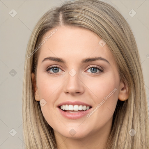 Joyful white young-adult female with long  brown hair and grey eyes