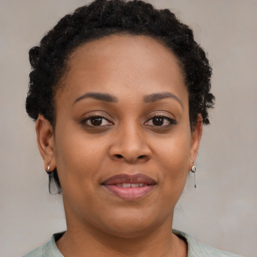 Joyful black young-adult female with short  brown hair and brown eyes