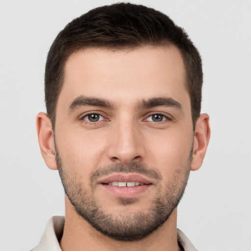 Joyful white young-adult male with short  brown hair and brown eyes