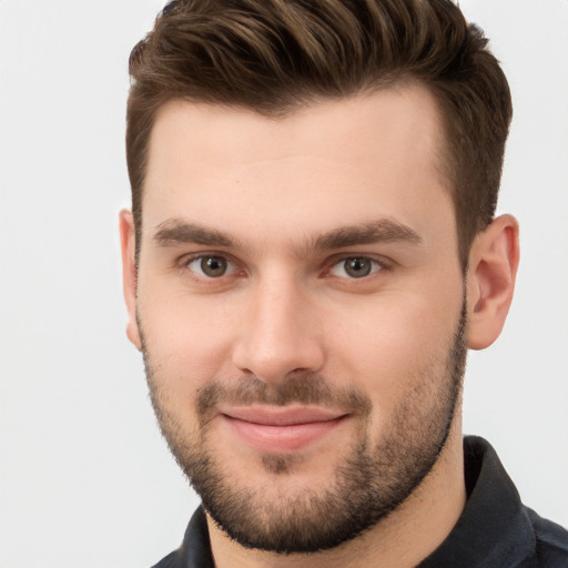 Joyful white young-adult male with short  brown hair and brown eyes