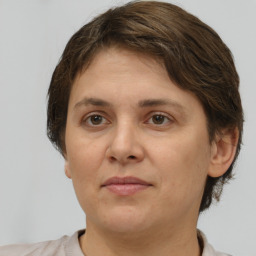 Joyful white adult female with short  brown hair and brown eyes