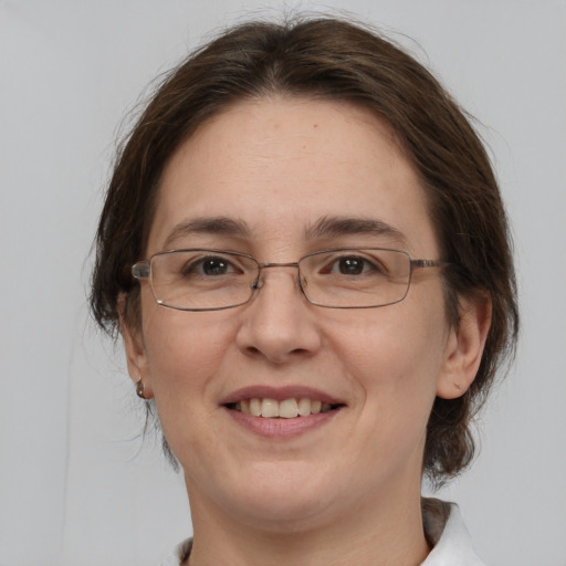 Joyful white adult female with medium  brown hair and brown eyes