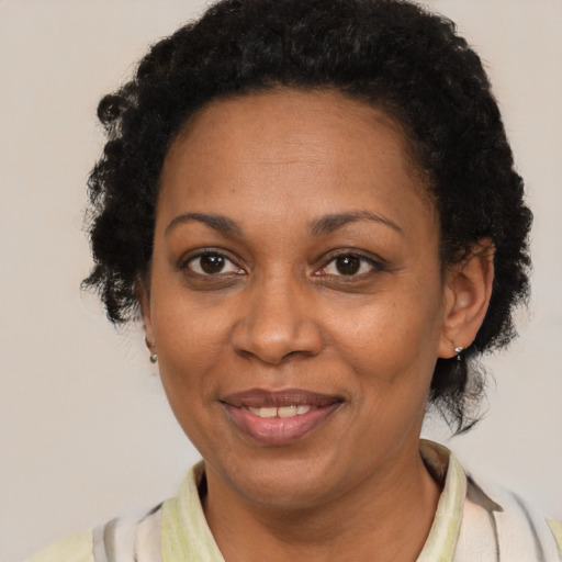 Joyful black adult female with short  brown hair and brown eyes