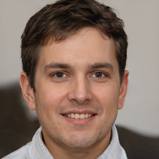 Joyful white adult male with short  brown hair and brown eyes