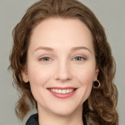 Joyful white young-adult female with medium  brown hair and green eyes