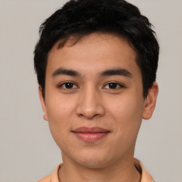 Joyful asian young-adult male with short  black hair and brown eyes