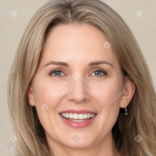 Joyful white adult female with long  brown hair and brown eyes