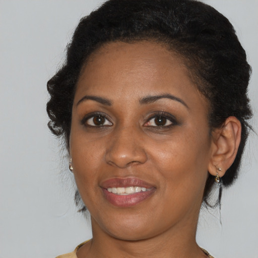 Joyful black young-adult female with medium  brown hair and brown eyes