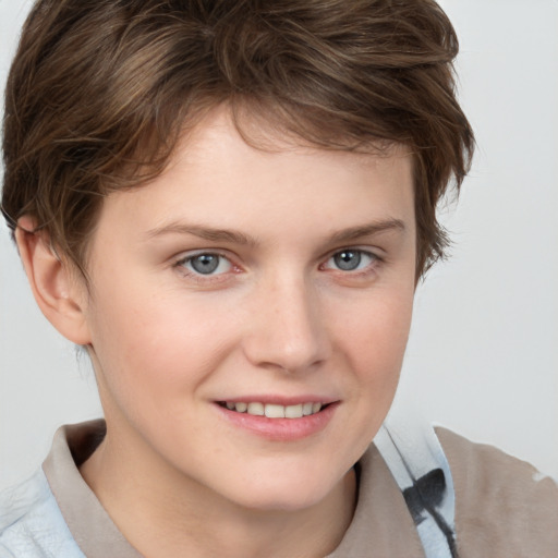 Joyful white young-adult female with short  brown hair and blue eyes