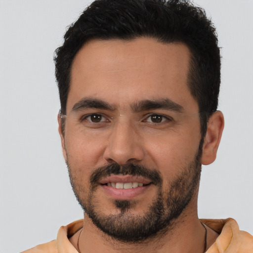 Joyful white young-adult male with short  black hair and brown eyes