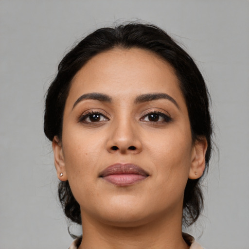 Joyful latino young-adult female with medium  black hair and brown eyes