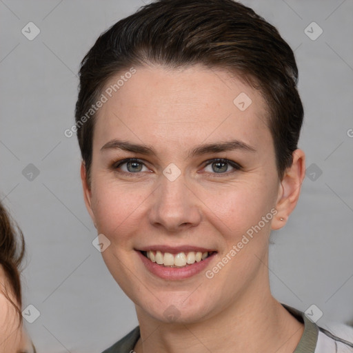 Joyful white young-adult female with short  brown hair and grey eyes