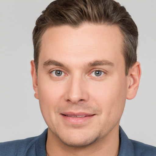 Joyful white young-adult male with short  brown hair and brown eyes