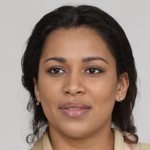 Joyful latino young-adult female with medium  brown hair and brown eyes