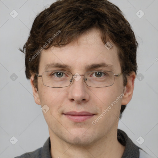 Joyful white adult male with short  brown hair and grey eyes