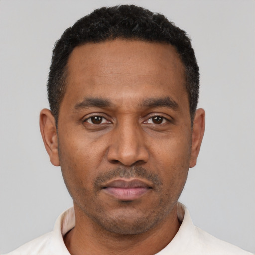 Neutral latino adult male with short  black hair and brown eyes
