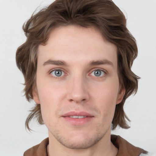 Joyful white young-adult male with medium  brown hair and grey eyes