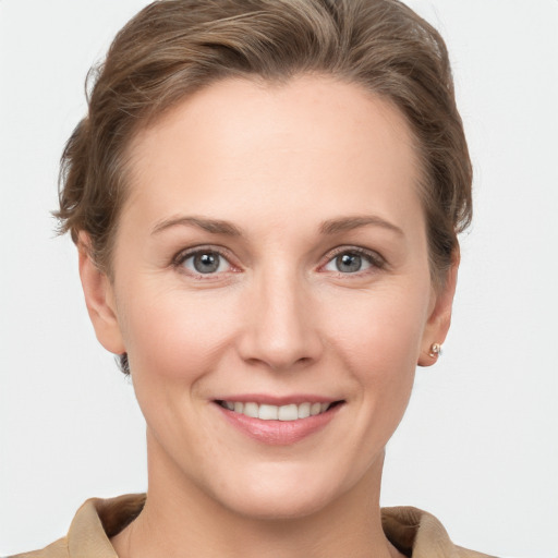 Joyful white young-adult female with short  brown hair and grey eyes