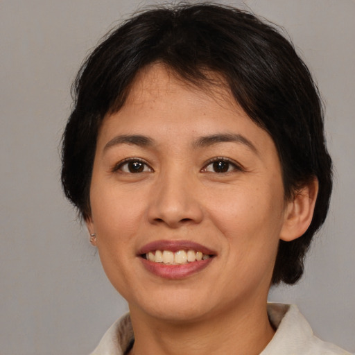 Joyful asian young-adult female with medium  brown hair and brown eyes