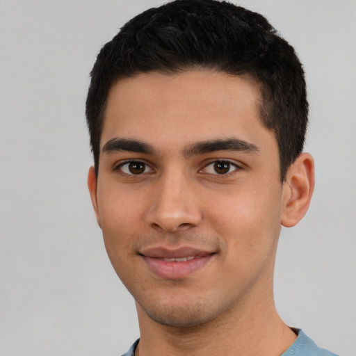 Joyful latino young-adult male with short  brown hair and brown eyes