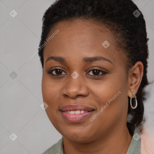 Joyful black young-adult female with long  brown hair and brown eyes