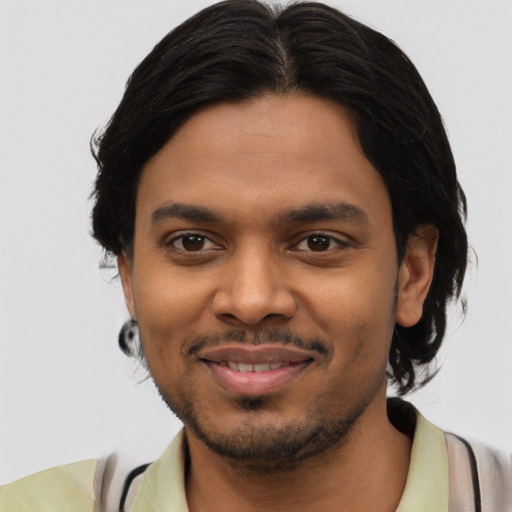 Joyful latino young-adult male with short  black hair and brown eyes