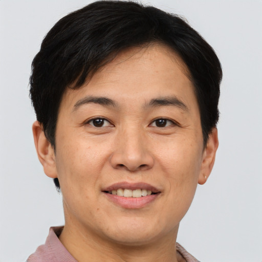 Joyful asian young-adult female with short  brown hair and brown eyes