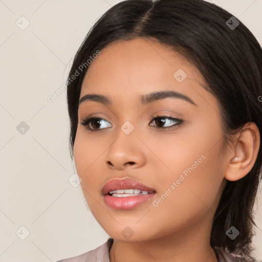 Joyful latino young-adult female with long  brown hair and brown eyes