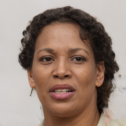 Joyful black adult female with short  brown hair and brown eyes