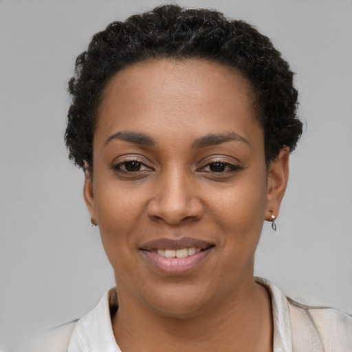 Joyful latino young-adult female with short  black hair and brown eyes